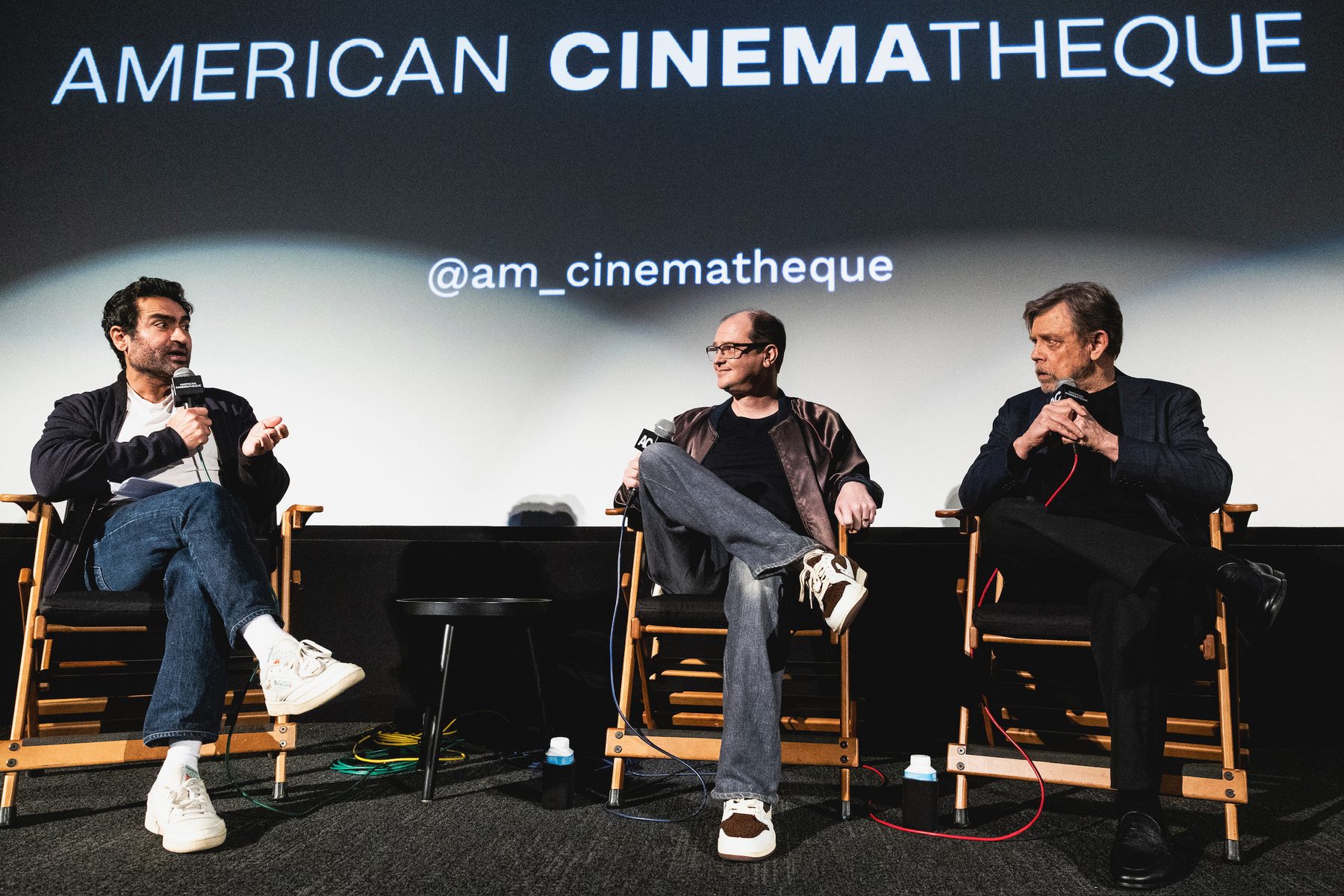 Panel guests in director chairs at a cinematheque screening