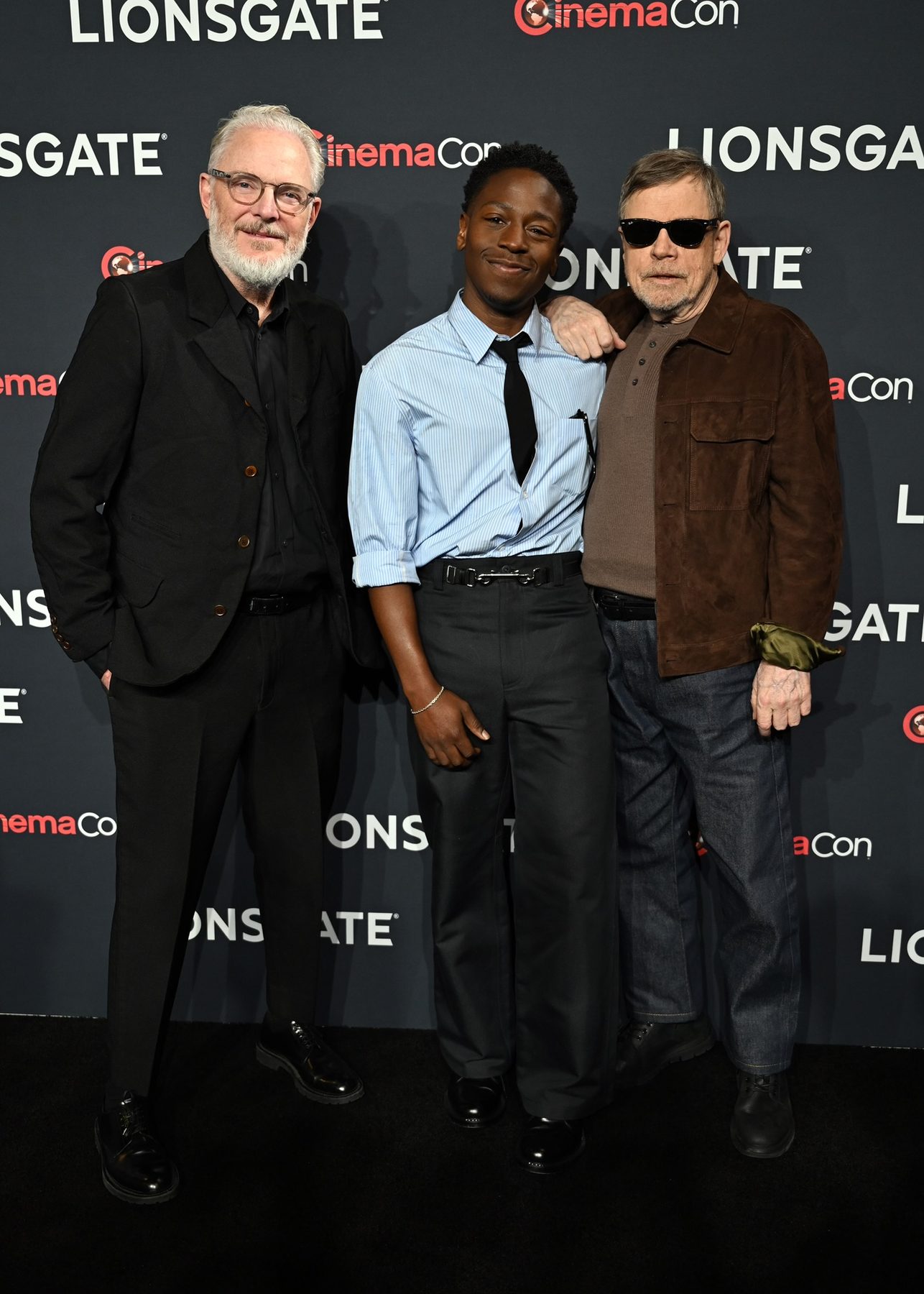 Mark Hamill with cast on a studio presentation carpet